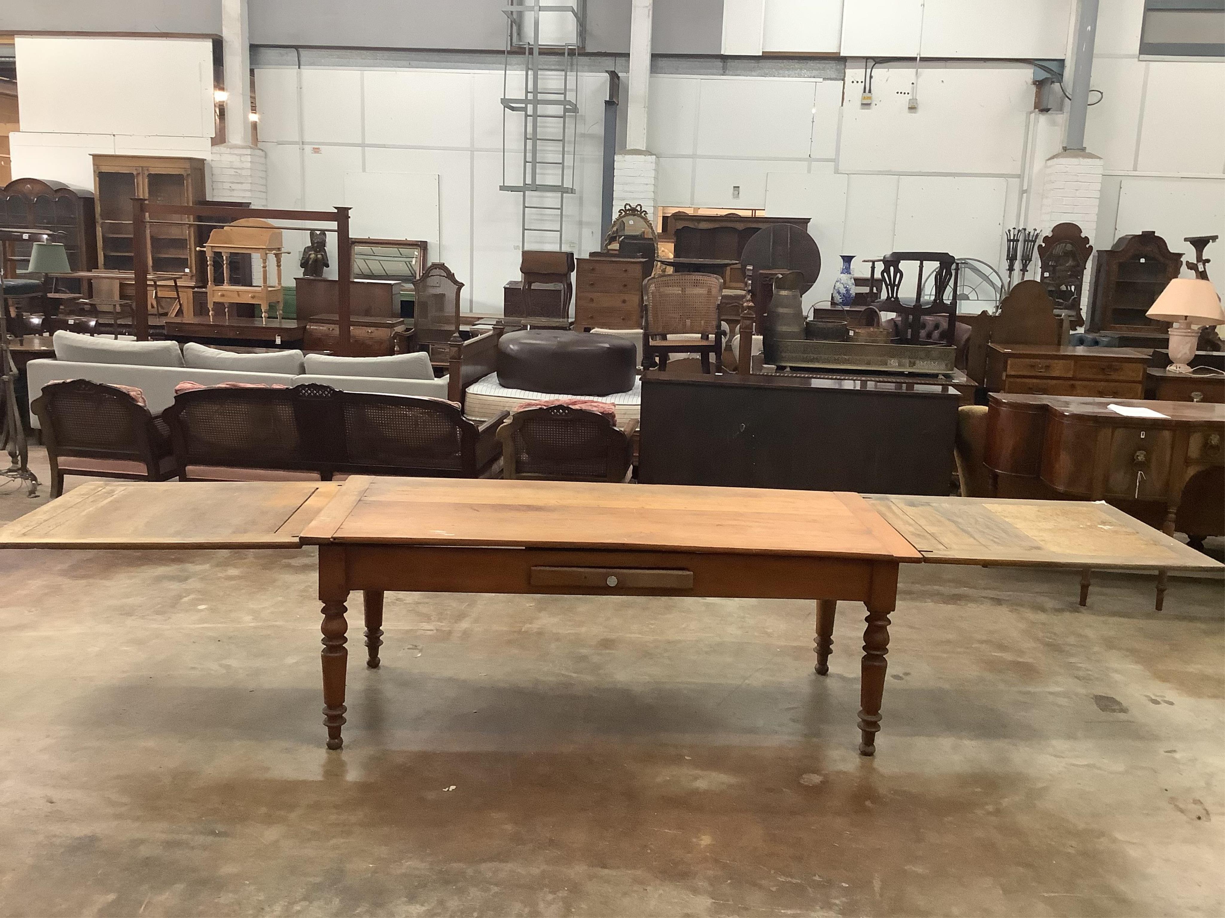 A 19th century French draw leaf kitchen table, width 200cm, depth 84cm, height 76cm. Condition - fair